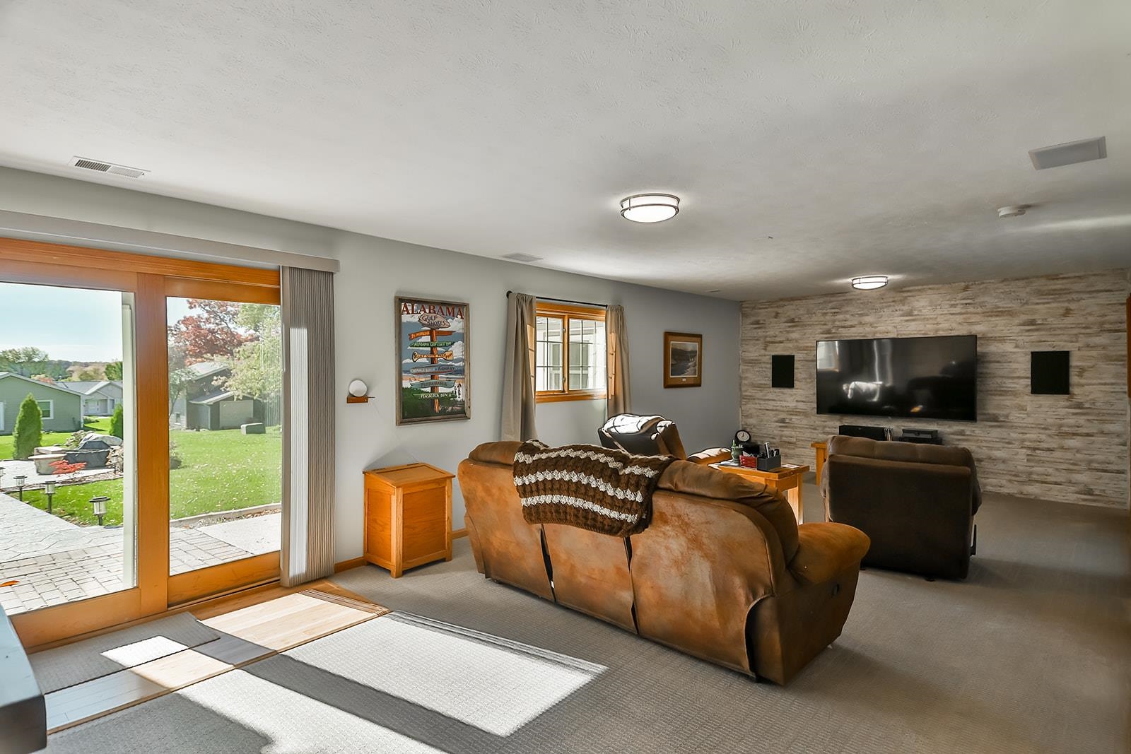 245 Rochester Road Northeast Poplar Grove, IL 61065 - Photo 25 of 29 a living room with furniture a flat screen tv and a refrigerator