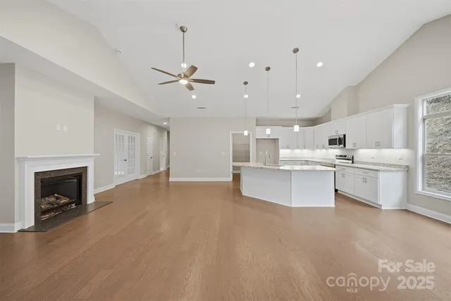 a view of kitchen with cabinets and fireplace
