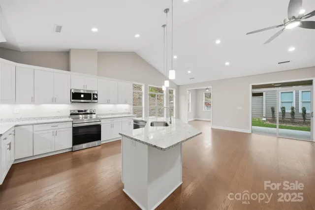 a kitchen with stove a sink and refrigerator
