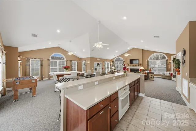 a living room with fireplace furniture and a large window