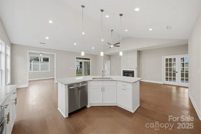 a large white kitchen with a sink and dishwasher stove top oven