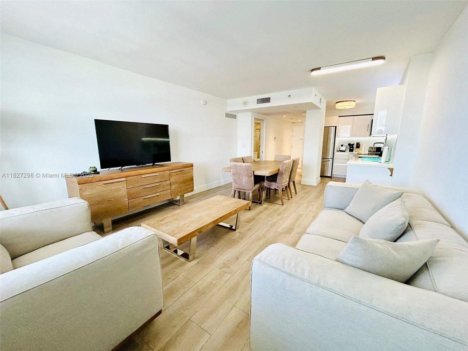100 Lincoln Road, Unit 1429 Miami Beach, FL 33139 - Photo 1 of 13 a living room with furniture and a flat screen tv