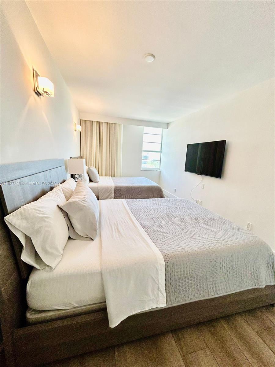 100 Lincoln Road, Unit 1429 Miami Beach, FL 33139 - Photo 6 of 13 a bedroom with a bed and a flat screen tv