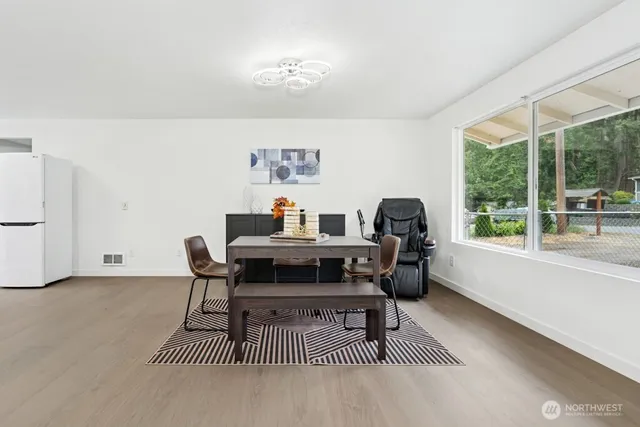 a living room with furniture a rug and a window