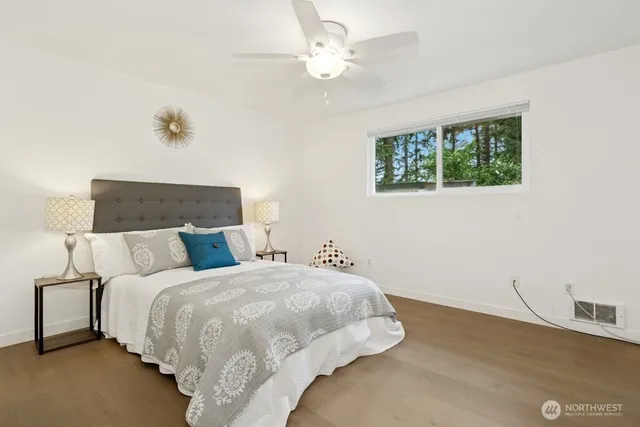 a bedroom with a bed and a ceiling fan