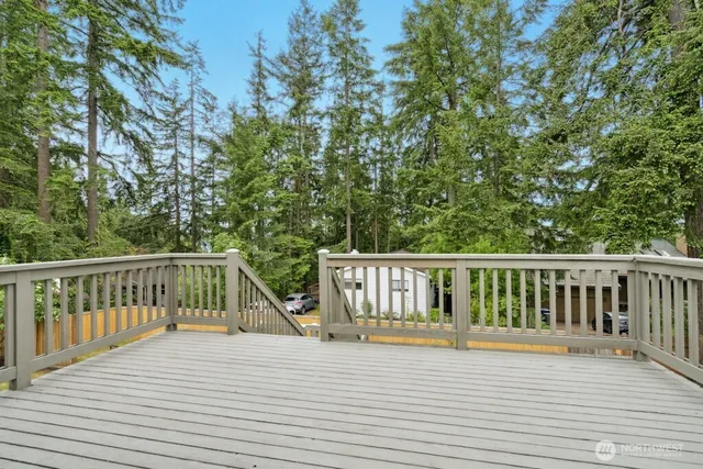 a view of balcony with wooden floor and fence