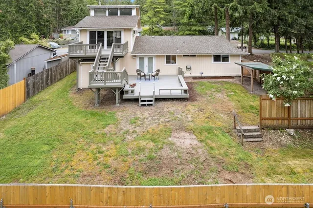 a backyard of a house with table and chairs