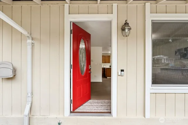 a view of a hallway with a door and couch