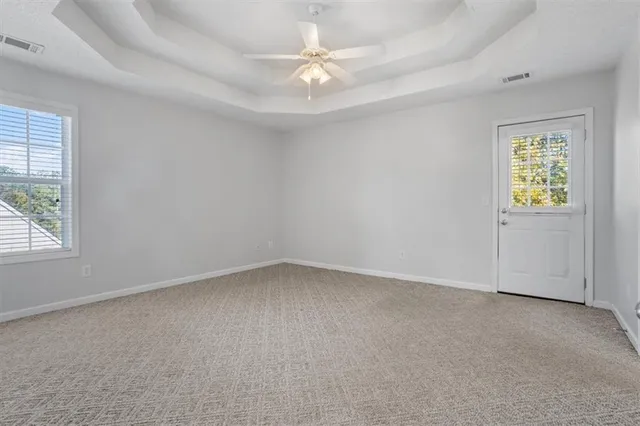 an empty room with closet and a flat screen tv