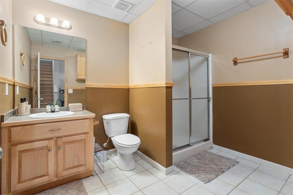 12 Moorings Run Jasper, GA 30143 - Photo 36 of 54 a bathroom with a granite countertop toilet a sink and a mirror