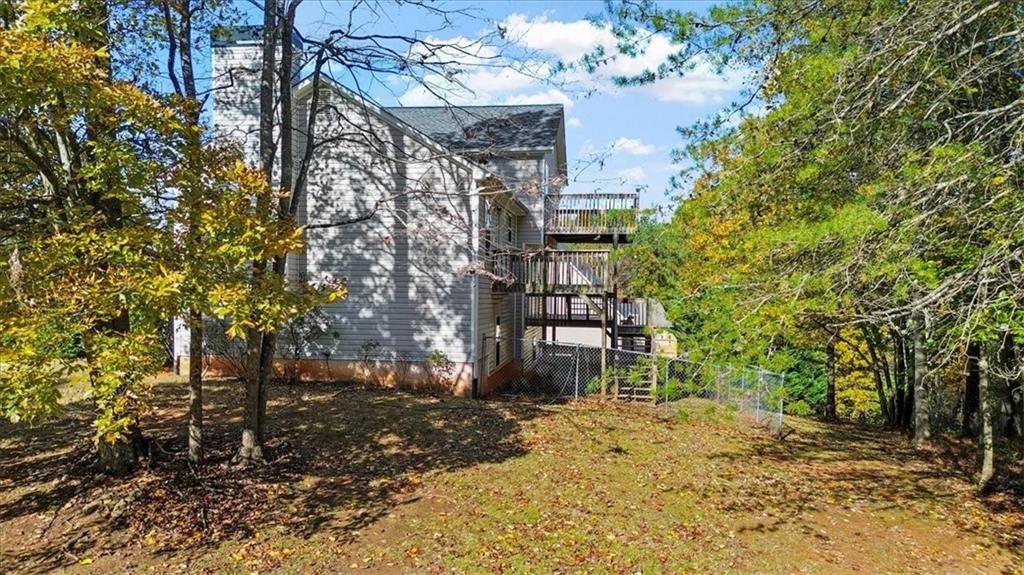 12 Moorings Run Jasper, GA 30143 - Photo 44 of 54 a backyard of a house with large trees and outdoor seating