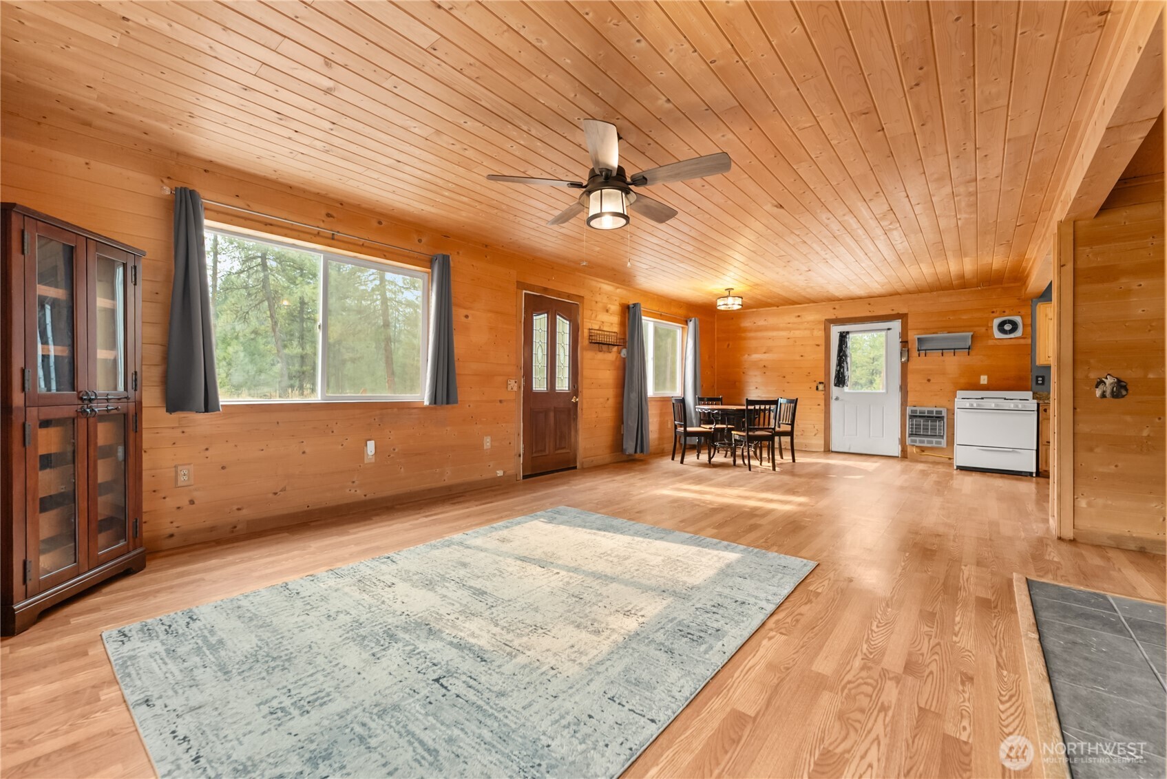 56 Ruby Two Moons Road Tonasket, WA 98855 - Photo 12 of 40 a view of a livingroom with furniture cabinets front door and a rug