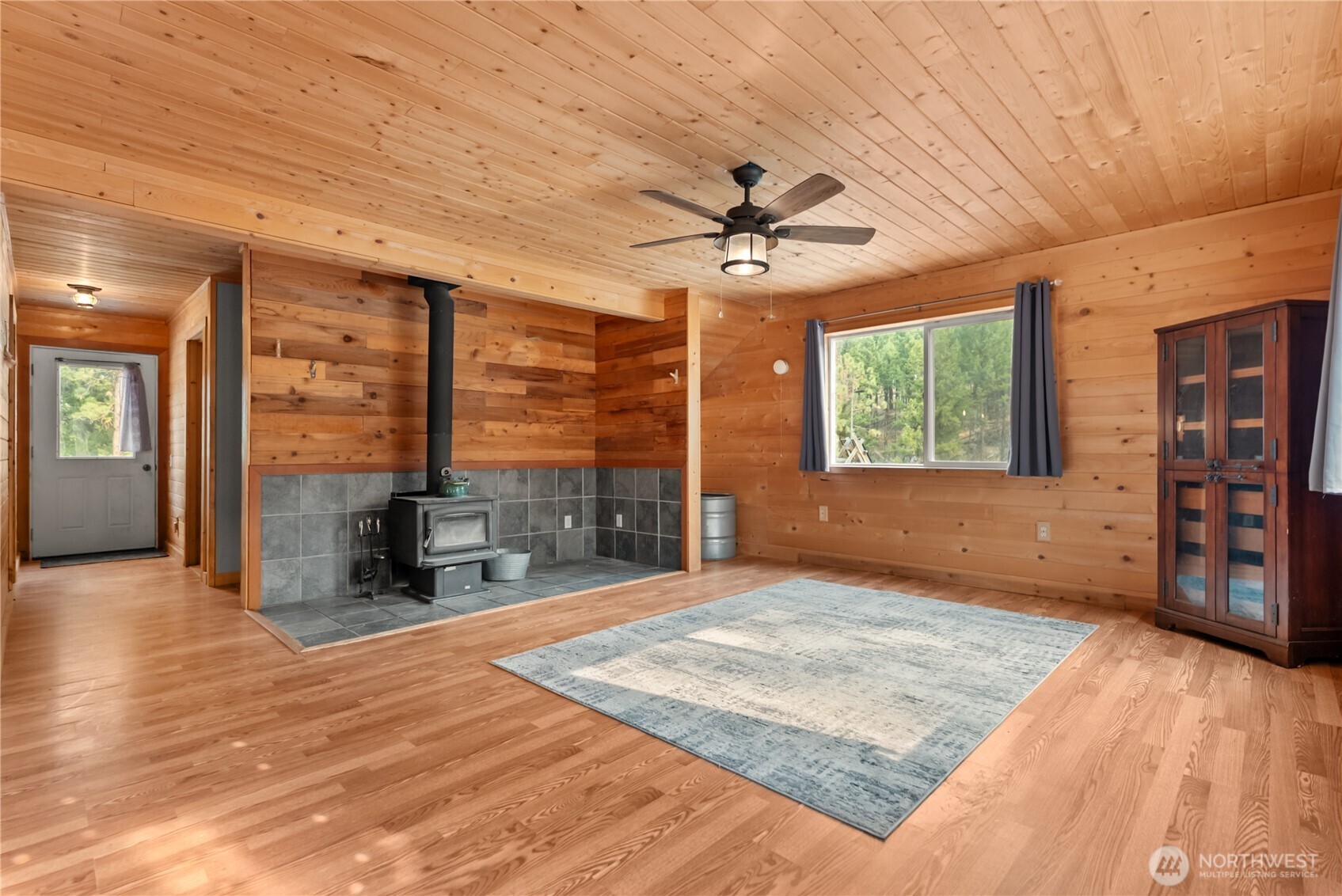 56 Ruby Two Moons Road Tonasket, WA 98855 - Photo 13 of 40 a view of an empty room with a window and wooden floor