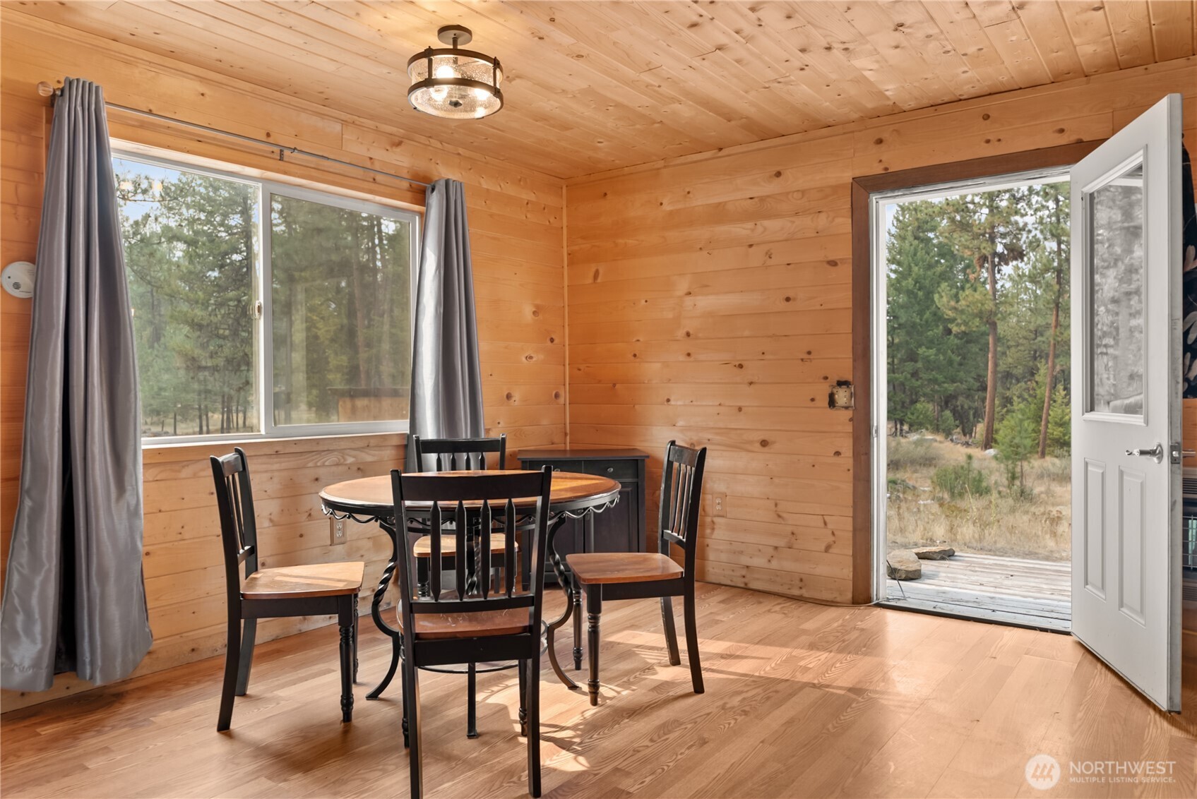 56 Ruby Two Moons Road Tonasket, WA 98855 - Photo 18 of 40 a view of a dining room with furniture window and outside view