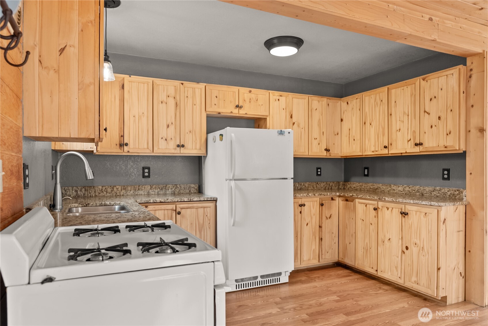 56 Ruby Two Moons Road Tonasket, WA 98855 - Photo 20 of 40 a kitchen with a stove a refrigerator and a more cabinets