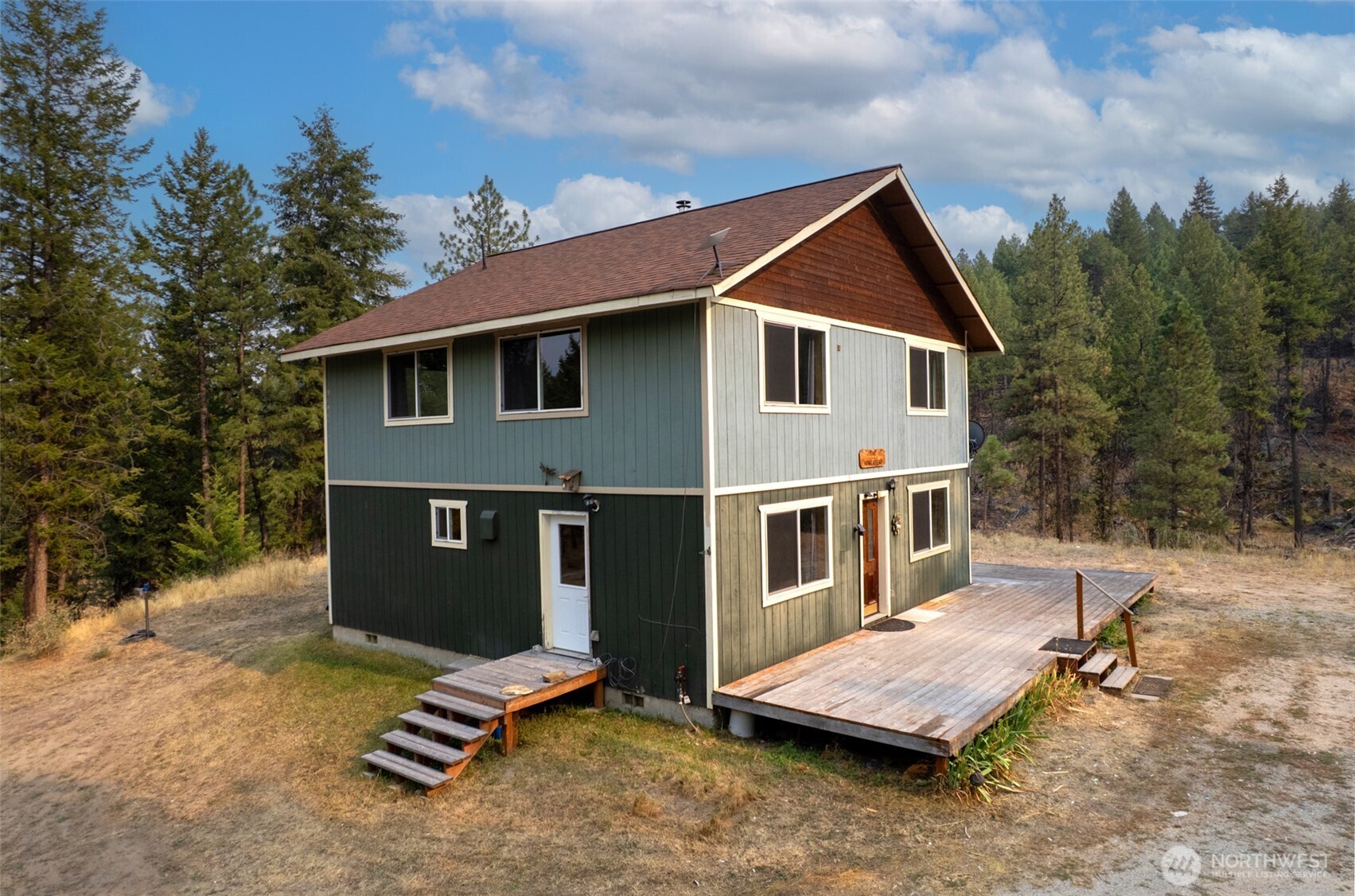 56 Ruby Two Moons Road Tonasket, WA 98855 - Photo 2 of 40 a front view of a house with a yard