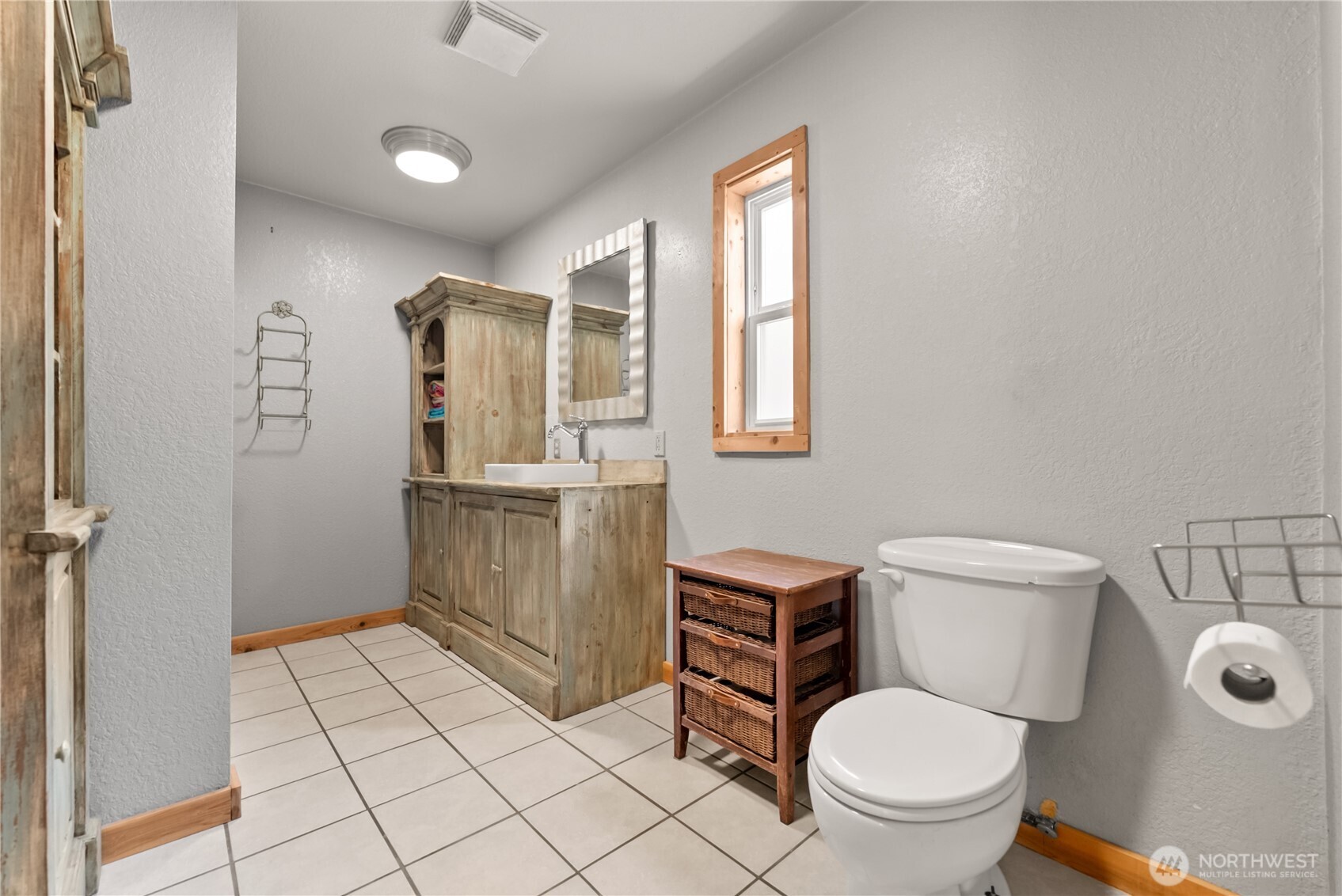 56 Ruby Two Moons Road Tonasket, WA 98855 - Photo 21 of 40 a bathroom with a toilet a sink and mirror