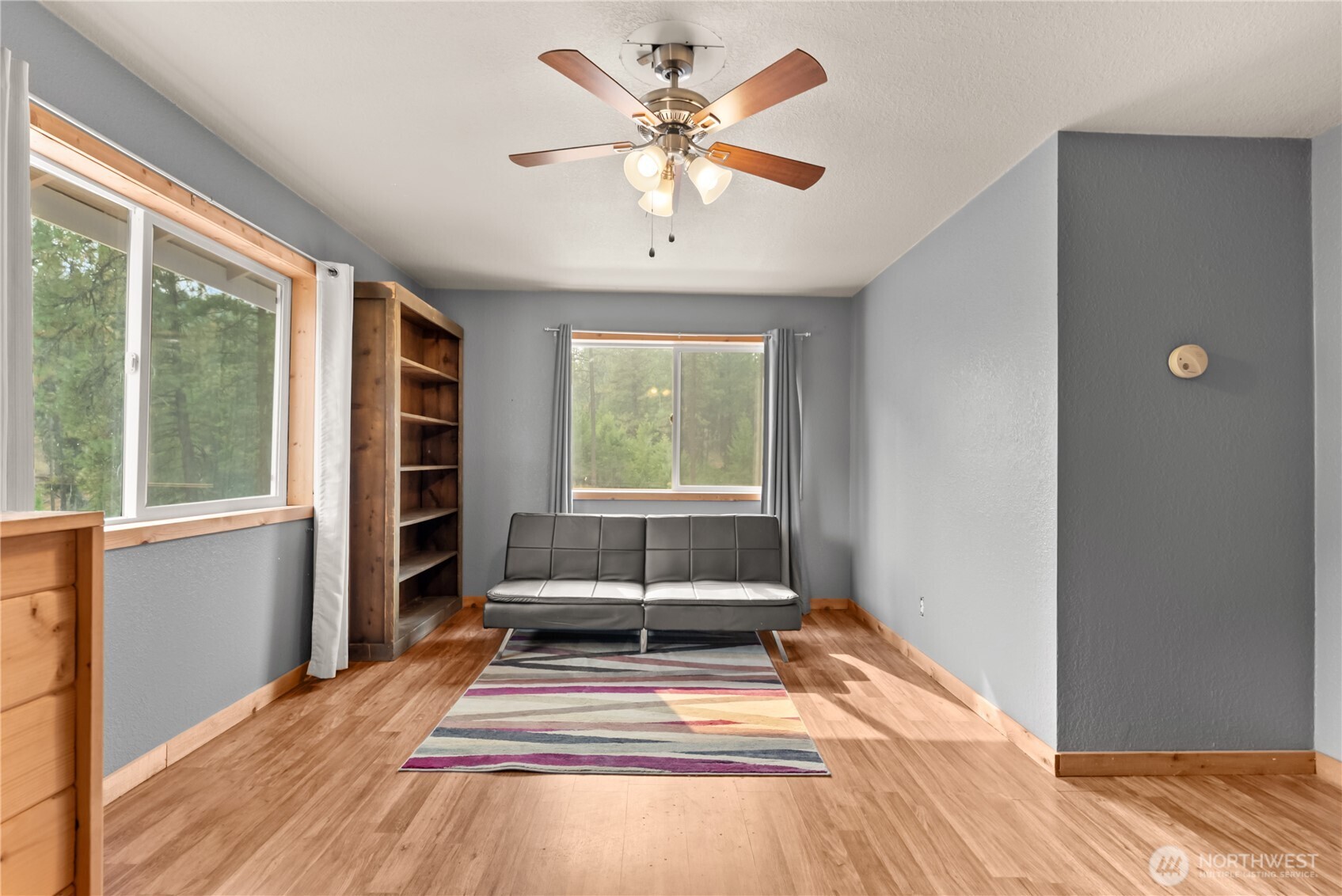 56 Ruby Two Moons Road Tonasket, WA 98855 - Photo 27 of 40 a view of a room with a large window and wooden floor