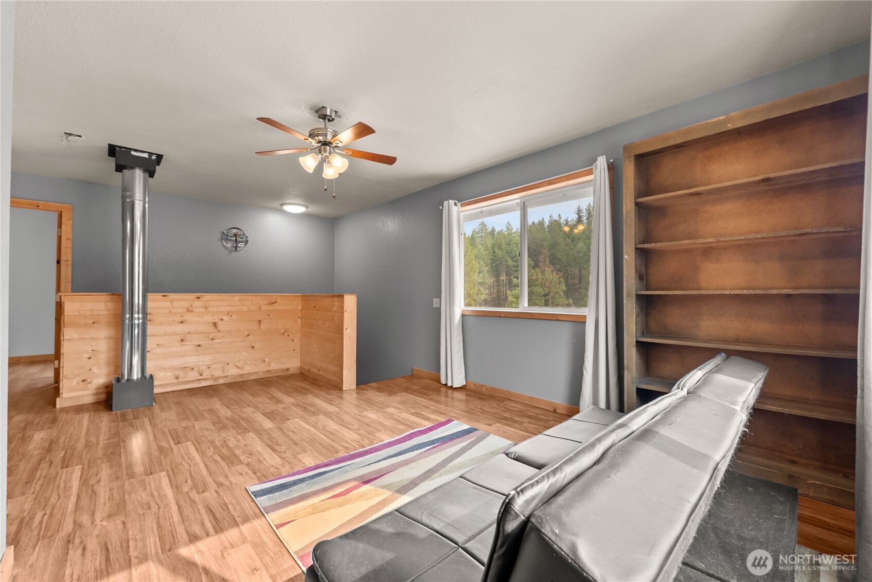 56 Ruby Two Moons Road Tonasket, WA 98855 - Photo 28 of 40 a bedroom with a bed and a chandelier