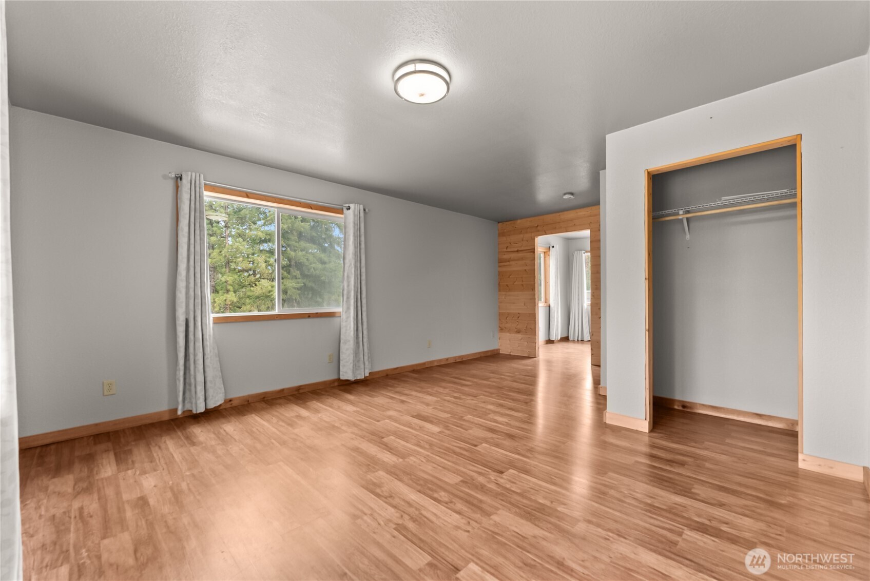 56 Ruby Two Moons Road Tonasket, WA 98855 - Photo 32 of 40 a view of an empty room with wooden floor and a window