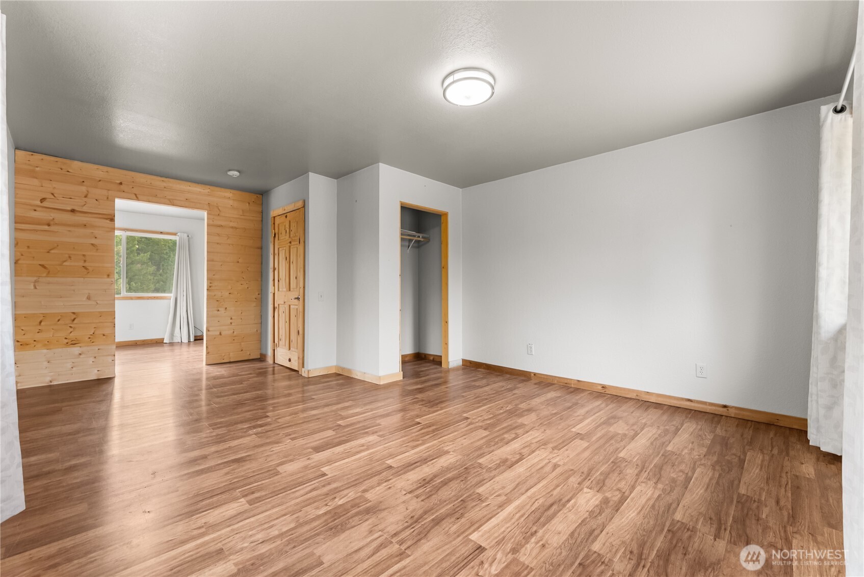 56 Ruby Two Moons Road Tonasket, WA 98855 - Photo 34 of 40 a view of an empty room with wooden floor and a window