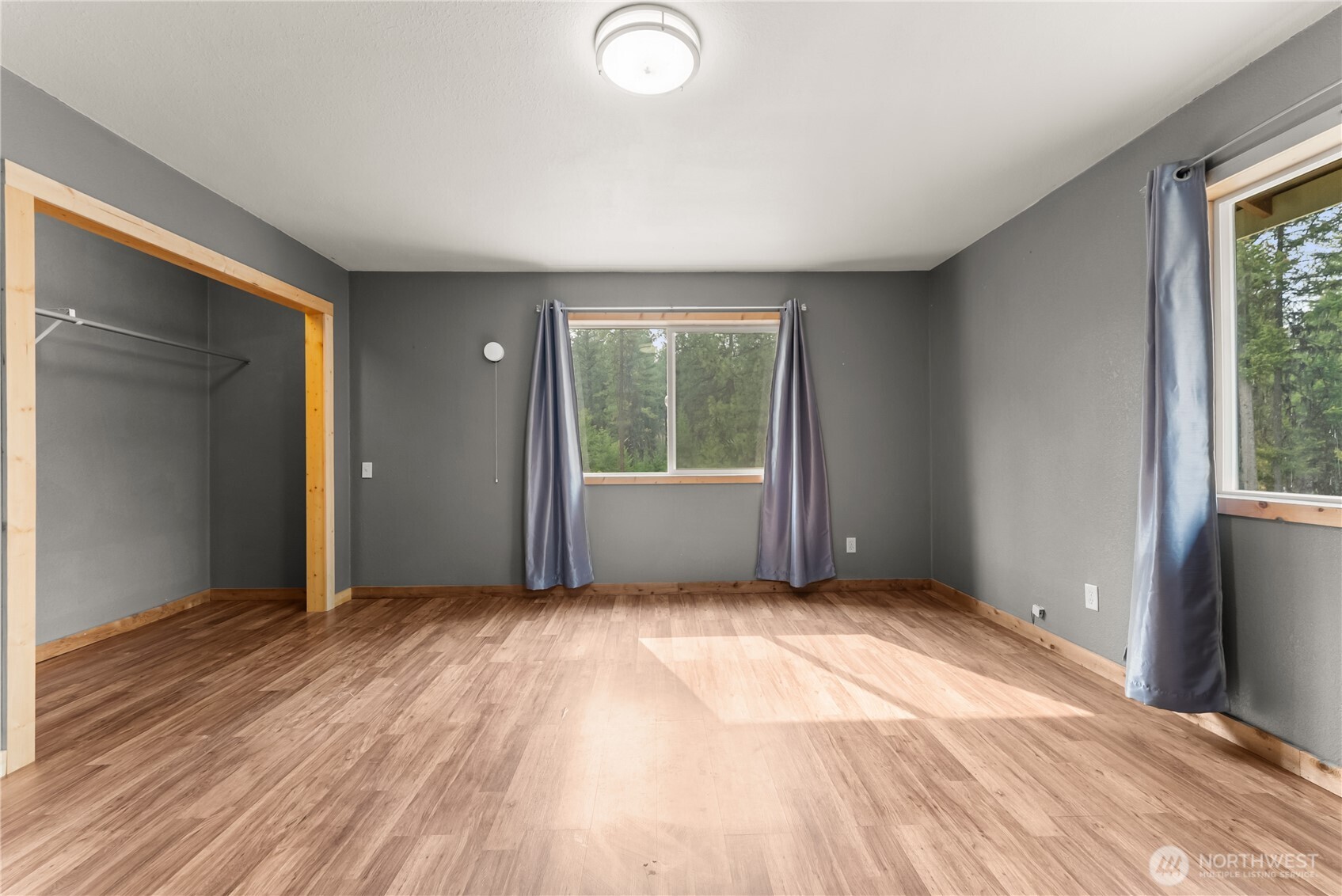 56 Ruby Two Moons Road Tonasket, WA 98855 - Photo 39 of 40 an empty room with wooden floor and windows