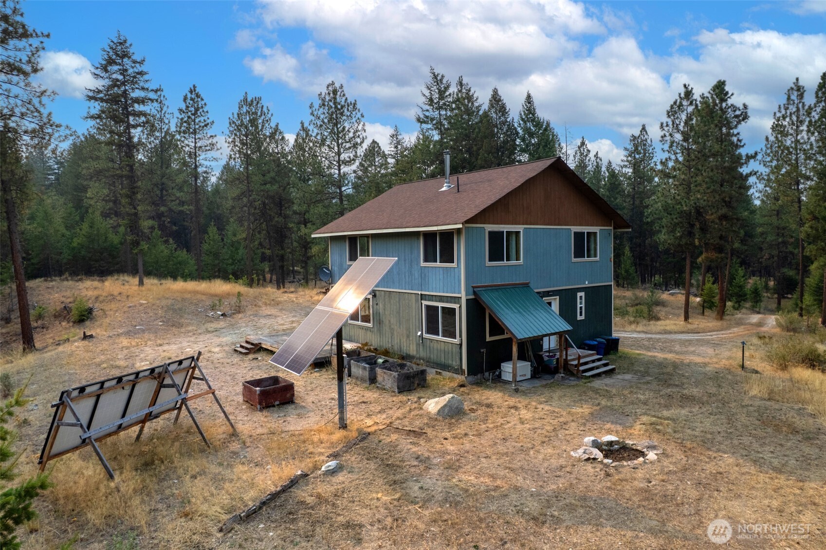 56 Ruby Two Moons Road Tonasket, WA 98855 - Photo 4 of 40 a view of a house with backyard and sitting area