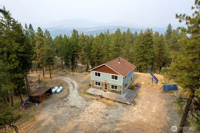 an aerial view of a house with a yard