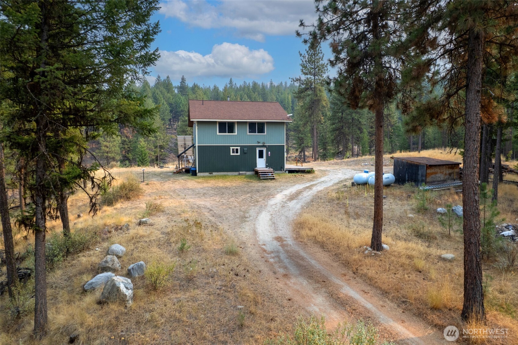 56 Ruby Two Moons Road Tonasket, WA 98855 - Photo 7 of 40 a view of a house with a yard