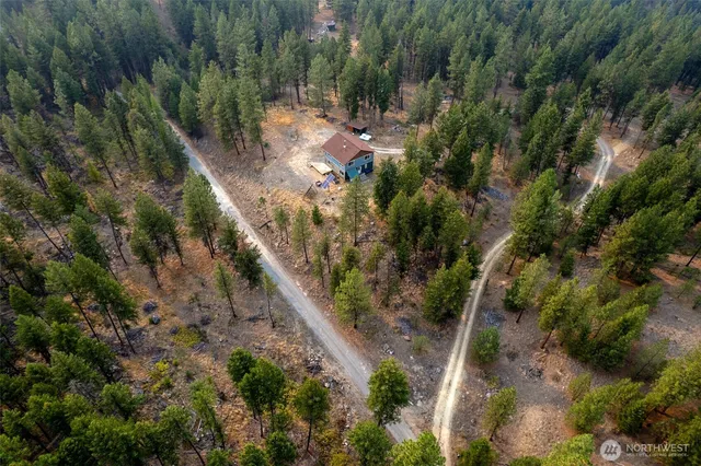 a view of a house with a forest