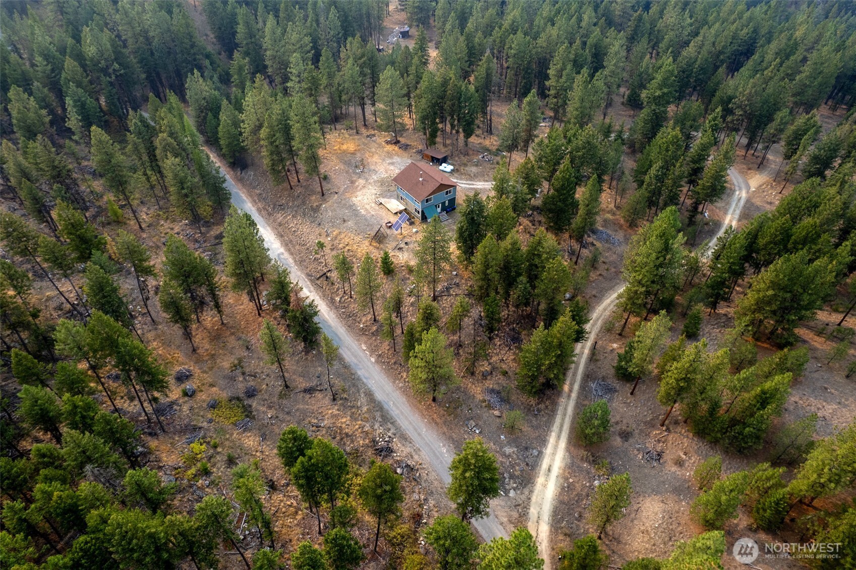 56 Ruby Two Moons Road Tonasket, WA 98855 - Photo 10 of 40 a view of a house with a forest