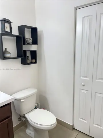 a white toilet sitting next to a bathroom sink
