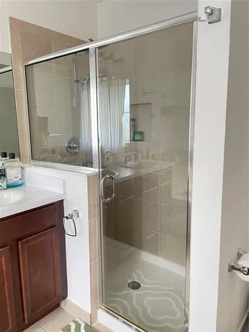 a bathroom with a shower and a sink