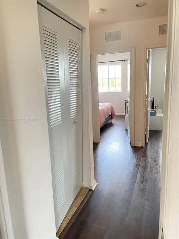 a bedroom with a bed and a white door