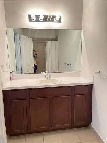 a bathroom with a toilet and a shower curtain