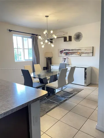 a living room with furniture and chandelier