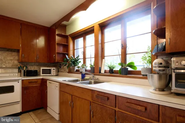 a kitchen with a sink and a stove top oven