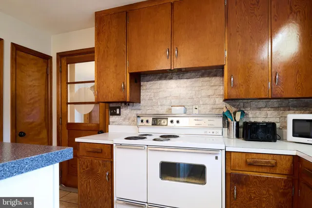a kitchen with appliances cabinets and a counter top space