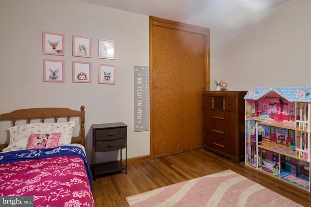 a bedroom with a bed and dresser