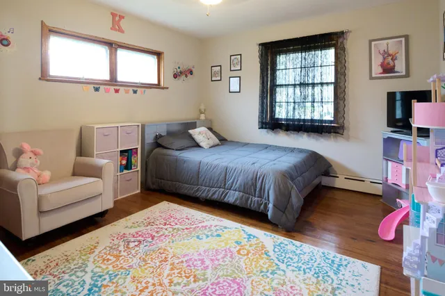 a bedroom with a bed window and couch