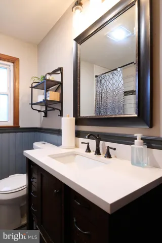 a bathroom with a sink vanity and a mirror