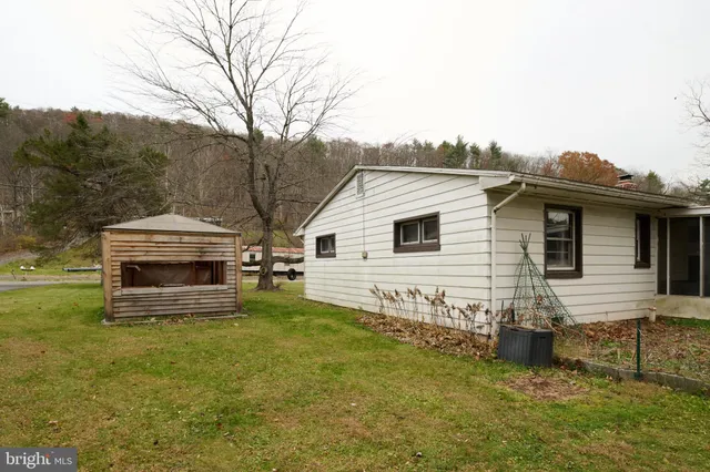 a view of a house with a yard and sitting area