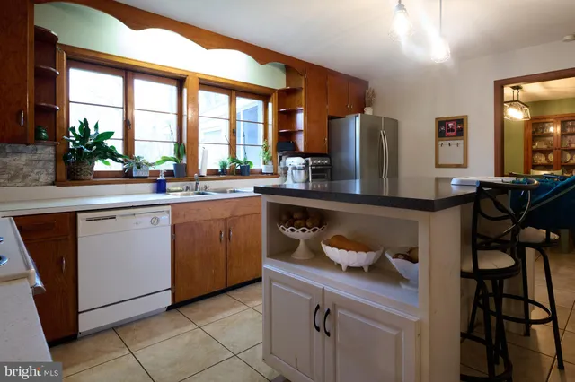 a kitchen with a sink cabinets and window
