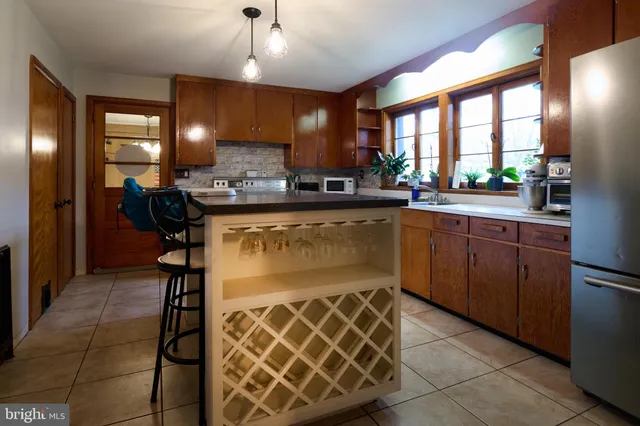 a kitchen with stainless steel appliances granite countertop a sink and a refrigerator