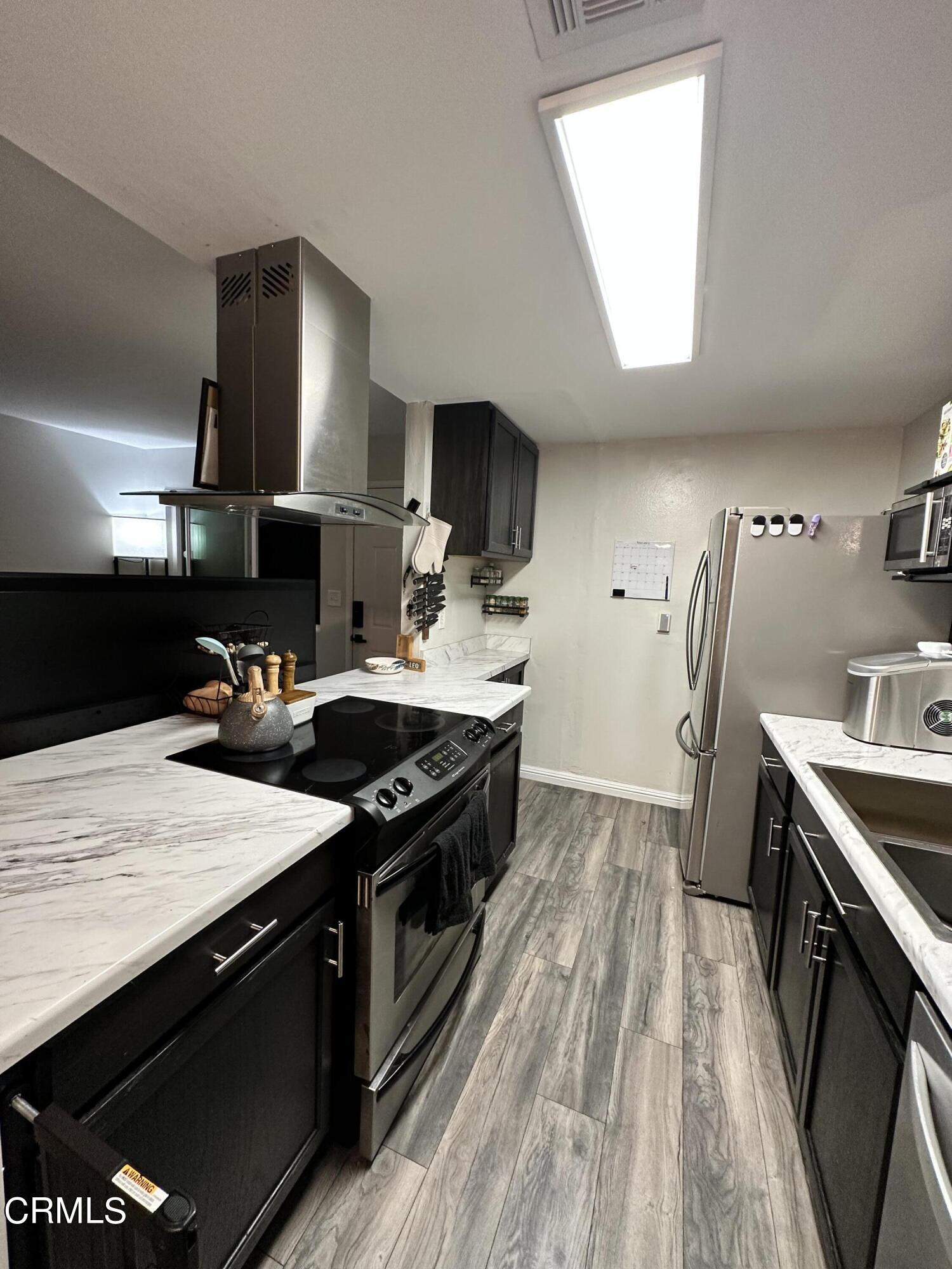 9926 Mission Vega Road, Unit 4 Santee, CA 92071 - Photo 12 of 22 a kitchen with a stove and a sink