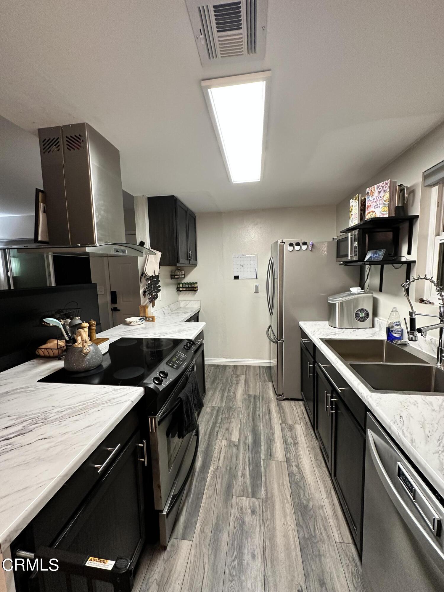9926 Mission Vega Road, Unit 4 Santee, CA 92071 - Photo 13 of 22 a kitchen with a sink stove top oven and cabinets