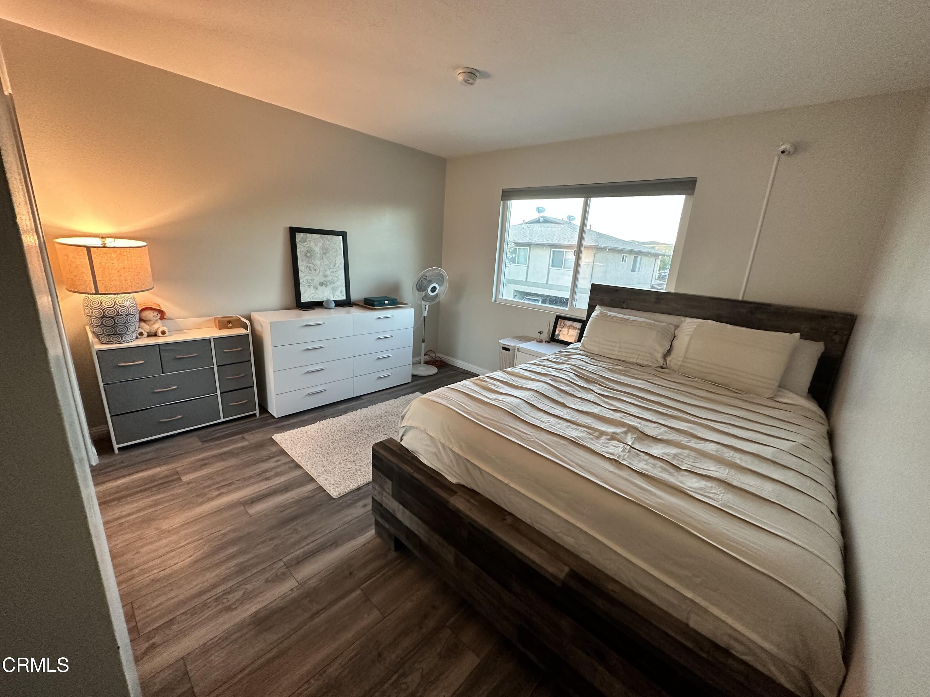 9926 Mission Vega Road, Unit 4 Santee, CA 92071 - Photo 15 of 22 a bedroom with a bed and wooden floor