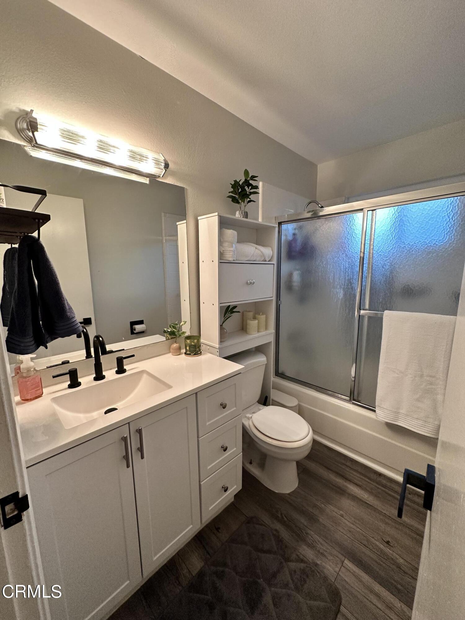 9926 Mission Vega Road, Unit 4 Santee, CA 92071 - Photo 19 of 22 a bathroom with a double vanity sink toilet mirror and shower