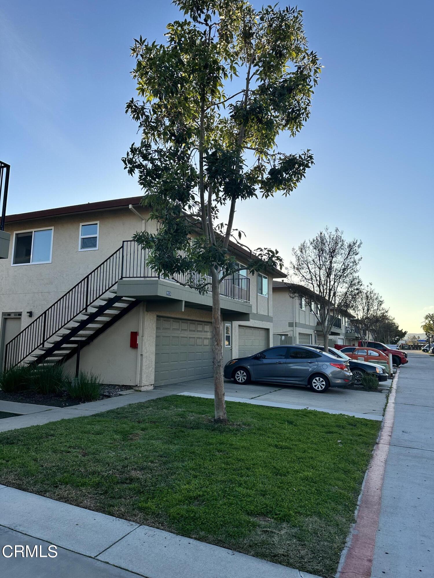 9926 Mission Vega Road, Unit 4 Santee, CA 92071 - Photo 3 of 22 a front view of house with yard and outdoor seating