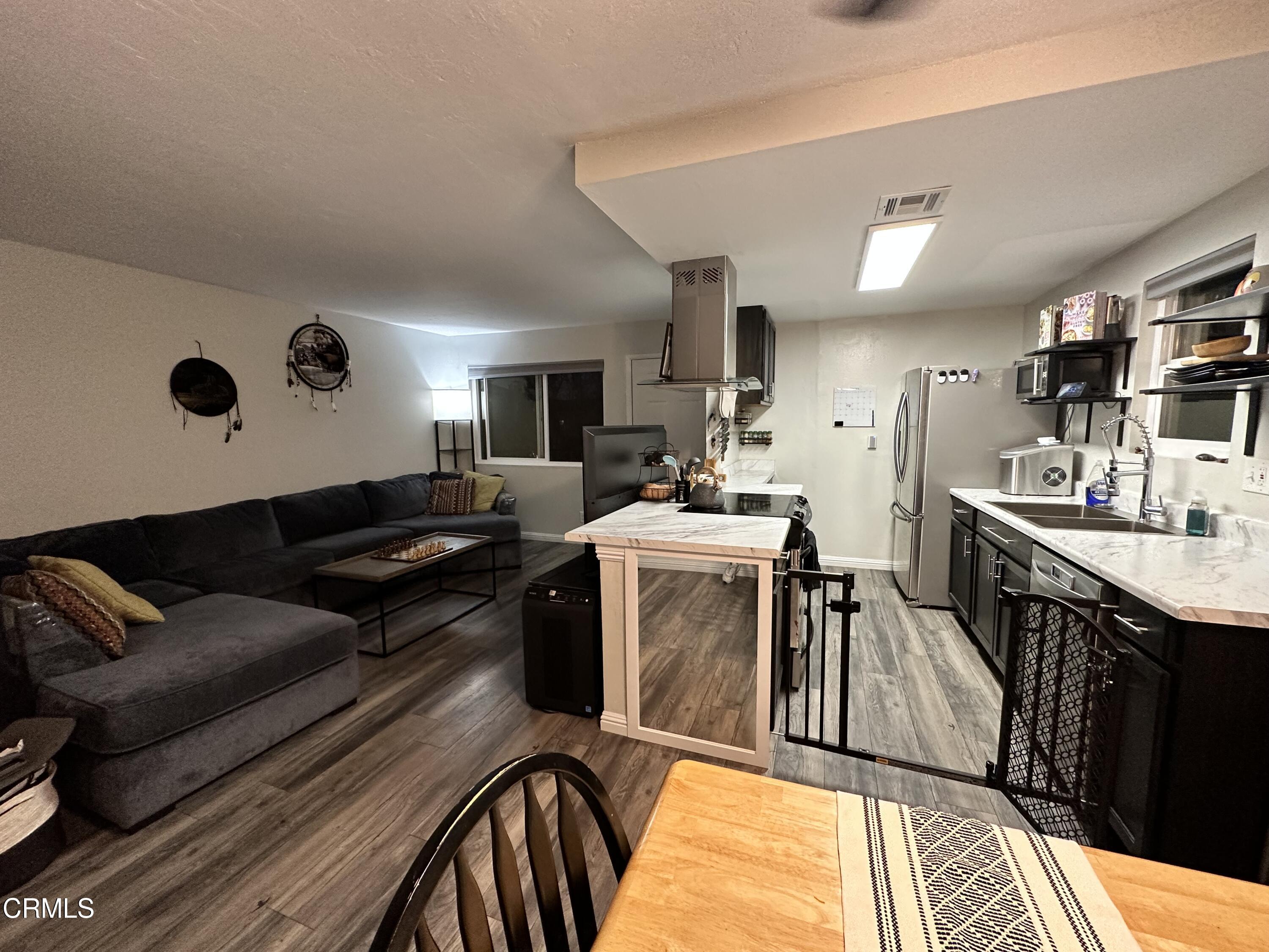 9926 Mission Vega Road, Unit 4 Santee, CA 92071 - Photo 7 of 22 a living room with stainless steel appliances kitchen island granite countertop furniture and a kitchen view